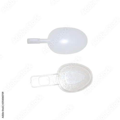 Two translucent measuring spoons for supplements or powders isolated on a white studio surface
