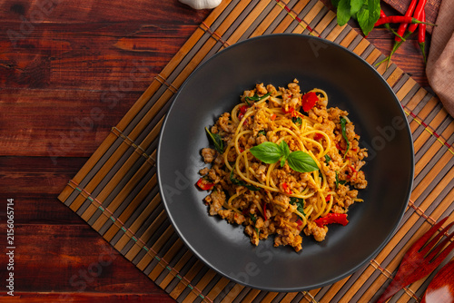 Stir fried spaghetti with minced pork and thai basil leaves.spicy thai fusion food.Pad Kra Pao.Top view.copy space.