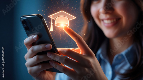 Smiling young woman uses smartphone to access online education. Glowing graduation cap icon appears on screen as touches mobile device. Digital learning concept for student studying college courses