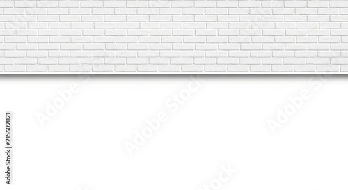 A white brick wall with a gray ledge