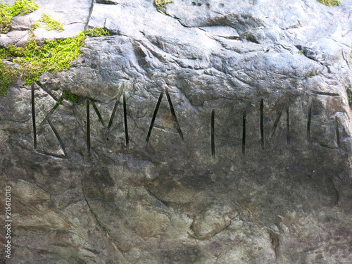 Mysterious inscription on a large gray stone near the village of Novoselovo, Russia