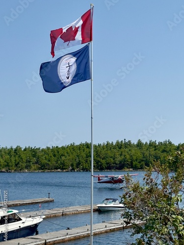 Flagpole on a Northern Ontario Lake with seaplane and marina