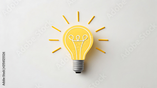Bright yellow lightbulb glowing with innovation and creative ideas on white background