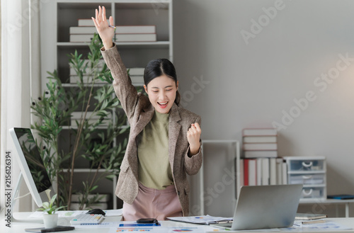 Konstfotografi Excited businesswoman celebrating success at her desk