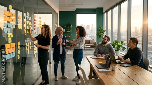 Diverse young business team collaborating during creative brainstorming meeting inside office