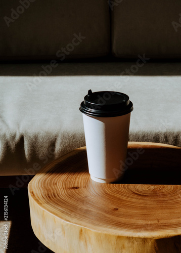 Takeaway Coffee Cup on Wooden Table in Sunlight