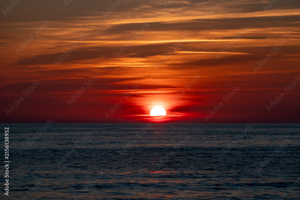 Fototapeta premium Sunset over calm ocean waves