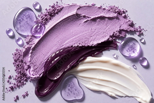 Luxury purple skincare texture composition featuring a velvety lavender mask, glossy plum gel, white cream and translucent violet droplets.