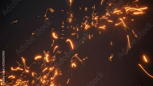 Bright Glowing Orange Sparks Flying Floating Against Dark Background