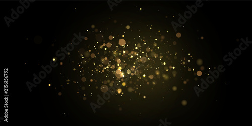 Obraz na plátně Scattered golden bokeh lights with varying sizes floating on a dark background o
