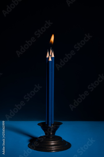 Foto Pencils Burning Like Candles in a Candelabrum