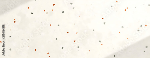Elegant white terrazzo texture background with colorful stone chips and soft natural light shadows for interior design