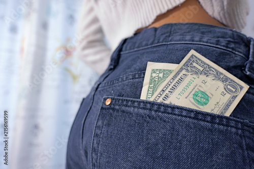 Dollar bills in back pocket of jeans