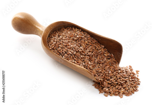 Flax seeds in wooden scoop isolated on white