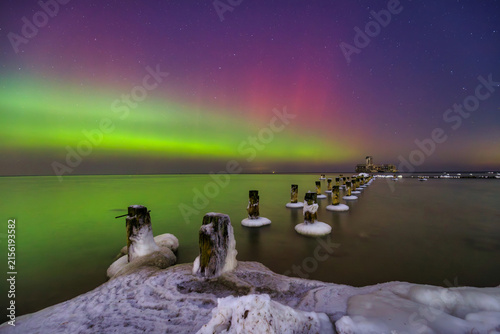 Baltic sea in Gdynia Babie Doly at winter night with northerm lights. Poland