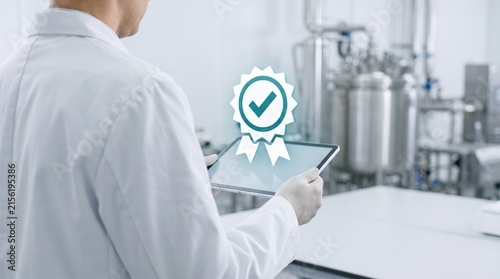 Quality control scientist using digital tablet with certification icon in pharmaceutical manufacturing facility for industrial compliance and standard assurance