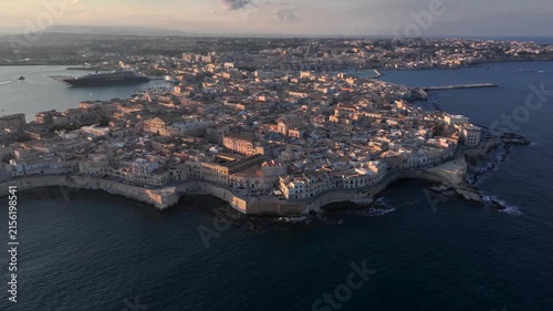Syracuse, Italy. Aerial of Ancient city on Sicily island, Maniace Castle surrounded by Mediterranean Sea at Sunset.