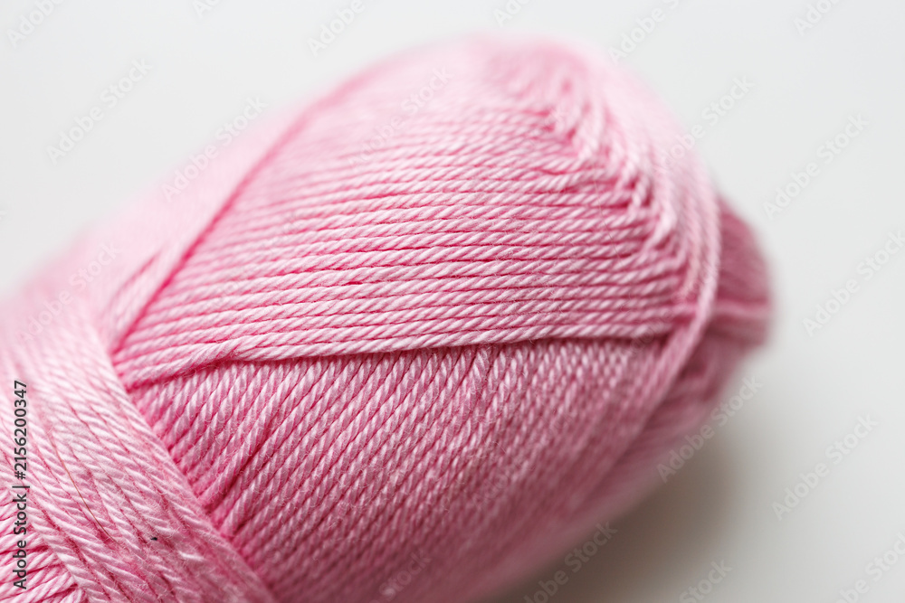 Fototapeta premium Pink yarn ball with twisted thread texture