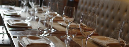 empty wine glass and plates on restaurant table dining background banner