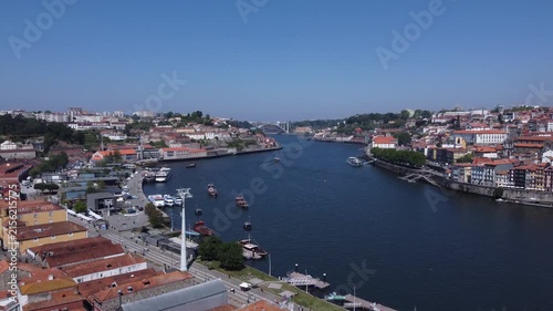 Porto, Portugal cityscape with the Douro River and historic bridges, featuring the Infante Bridge and Maria Pia Bridge, surrounded by traditional Portuguese architecture and scenic urban landscape.
