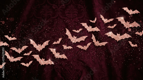 Sparkling bats flying across a dark velvet background, creating a festive Halloween atmosphere