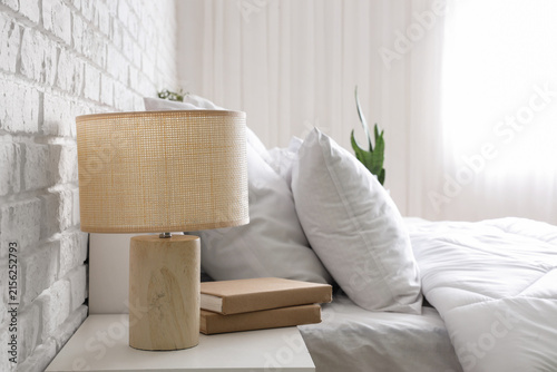 Wicker lamp with books on b...