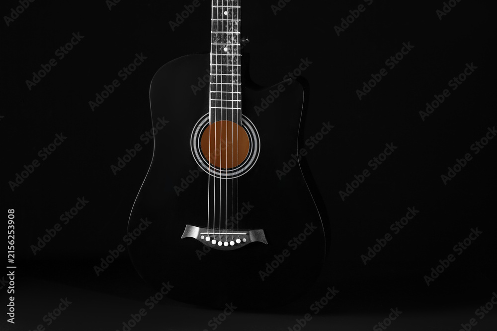 Fototapeta premium Acoustic guitar on black background, closeup