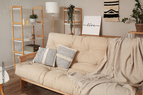 Cozy beige sofa with cushio...