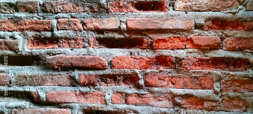 Damaged red brick wall