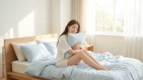햇살 드는 침실에서 베개를 안은 여성 · Woman Hugging Pillow on Bed in Sunlit Bedroom