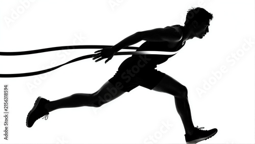 Silhouette of athlete sprinting with rope, dynamic motion captured in stark black and white.