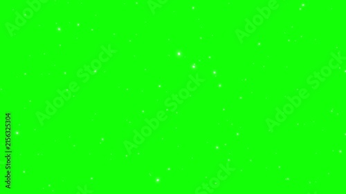 Green screen background features faint glowing dust particles floating across the frame.