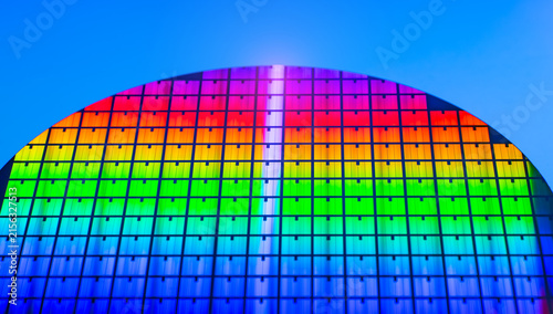 wafer silicon monocrystalline  with microchips after photolithography etching manufacturing reflecting different colors used in fabrication of electronic integrated circuits.