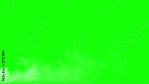 White smoke drifts along the bottom edge against a bright green screen.