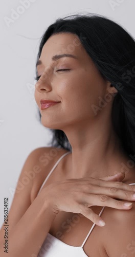 Close-Up Woman Touching Face and Neck in Beauty Studio