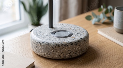 Circular Terrazzo Lamp Base with Metallic Center on Wooden Desk. Modern Minimalist Design, Home Office Accessory