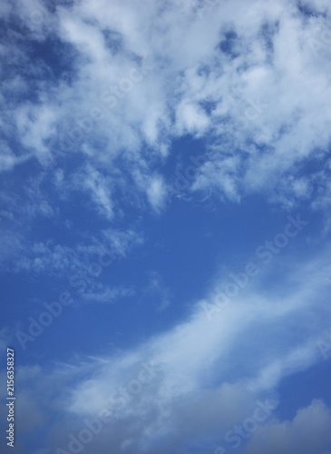 Photography The sky was clear blue, with sparse white clouds scattered throughout