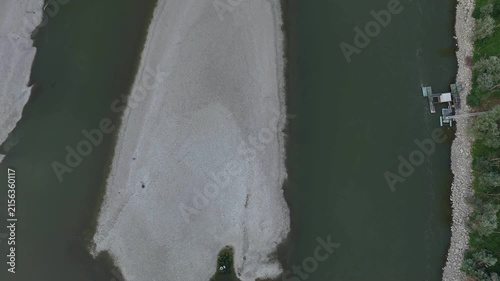 Po River near Isola Serafini, Monticelli d'Ongina, Piacenza, Emilia-Romagna, Italy, revealing an exposed mid-channel sandbar, channel narrowing, reduced wetted width and severe drought conditions