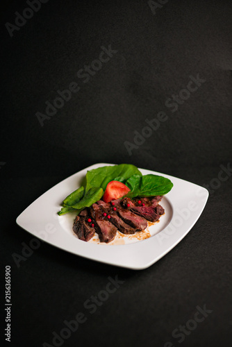 Obraz na plátně Gourmet beef steak served with fresh vegetables on a white ceramic plate