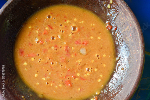 Traditional Indonesian rujak spice paste served in a clay mortar (cobek)