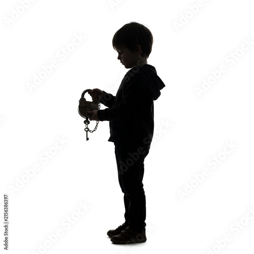 Silhouette of Child Holding Keys in Hand.
