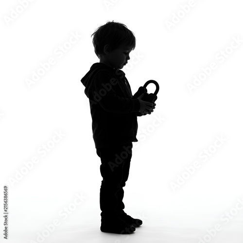 Silhouette of Child Holding Object in Profile View.