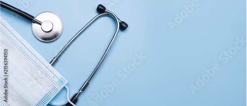 Stethoscope and Face Mask on Blue Background