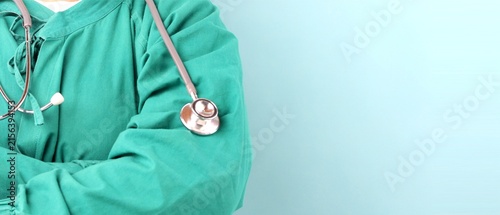 Doctor in Green Scrubs with Stethoscope on Light Blue Background