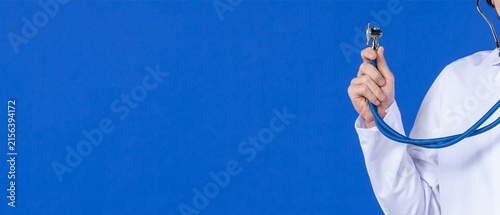 Doctor in White Coat Holding Stethoscope on Blue Background