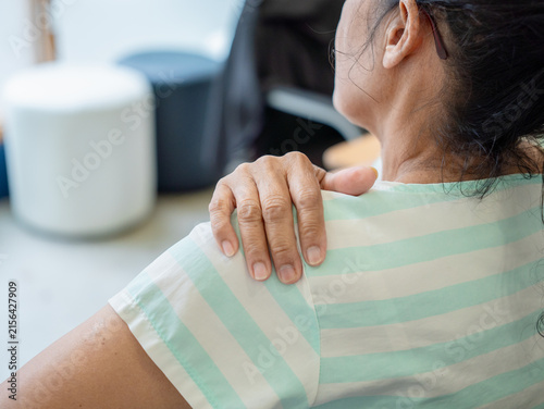 Konstfotografi Asian senior woman use hand squeeze nape to relieves symptoms cramps, pain muscle, osteoporosis