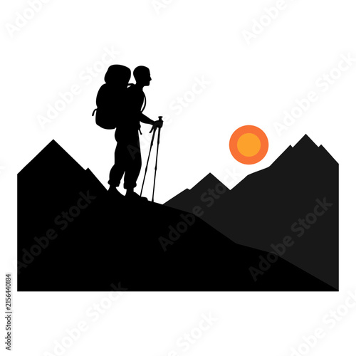 Silhouette of a hiker with backpack trekking on mountain peak at sunrise