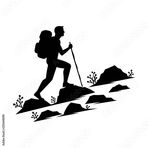 Silhouette of a hiker with backpack climbing a mountain trail for outdoor adventure.