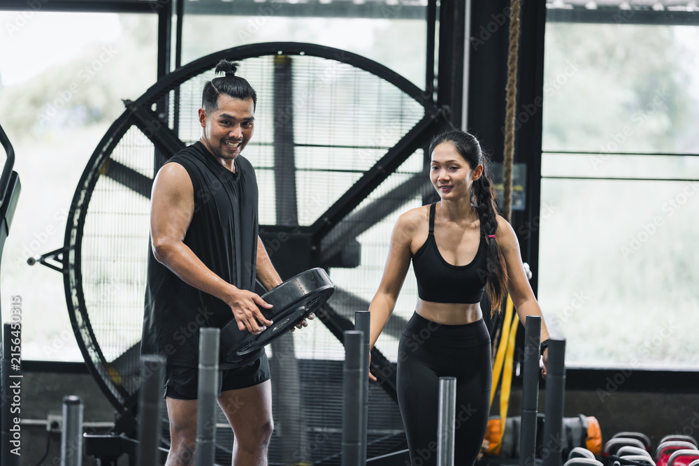 Fototapeta premium Man and woman exercise in gym