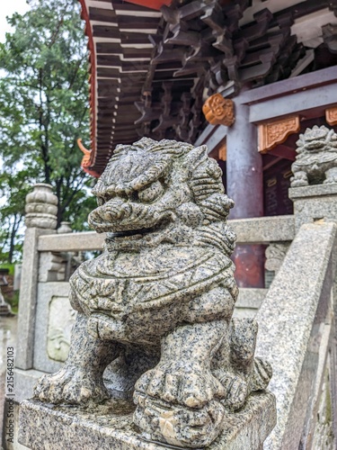 Konstfotografi Stone lion statue guarding traditional temple entrance